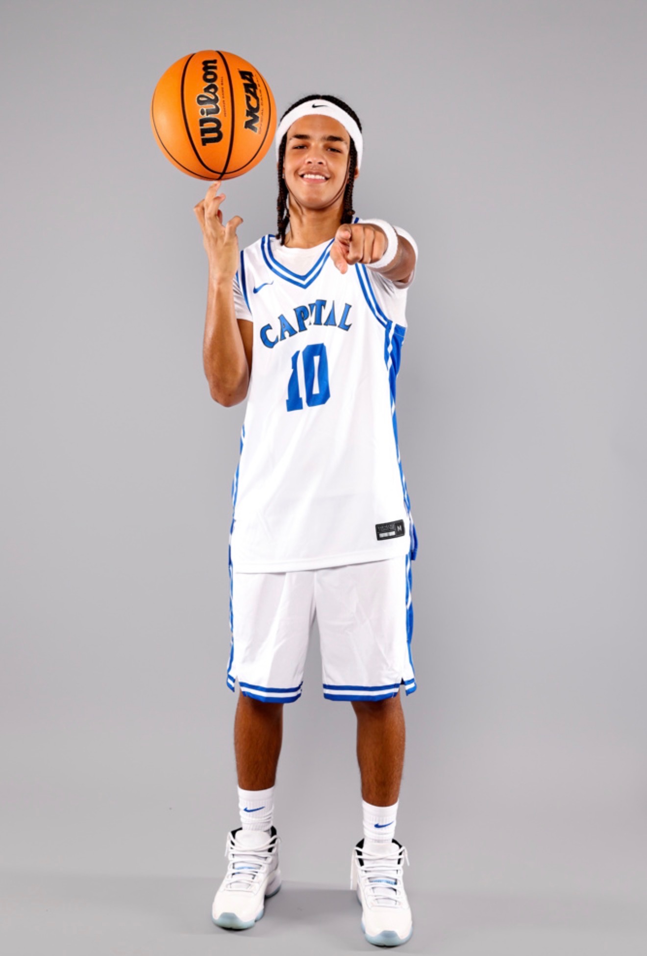 Kahsi Morgan pointing while spinning a basketball