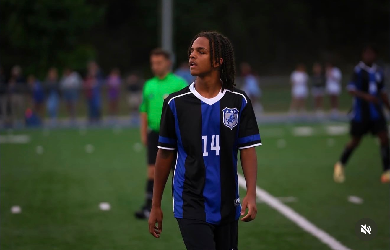Kahsi Morgan on the soccer field in black and blue jersey
